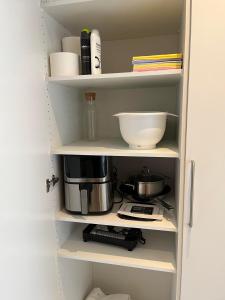 a kitchen shelf with a coffee maker and other kitchen items at Billund mini hostel room 3 in Billund +2 photos