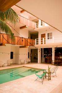 an image of a house with a swimming pool at Balu Hotel in Isla Mujeres
