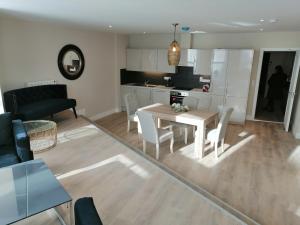 a kitchen and a living room with a table and chairs at The Patrick Lofts in Cork +14 photos