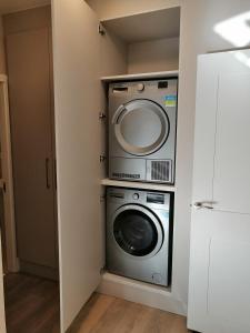a laundry room with a washer and dryer at The Patrick Lofts in Cork