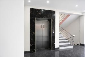 a elevator in a building with a staircase at FabHotel Golden Suites Near Puri Beach in Puri