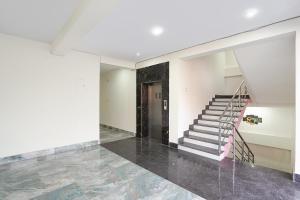 an empty room with a staircase in a house at FabHotel Golden Suites Near Puri Beach in Puri +30 photos