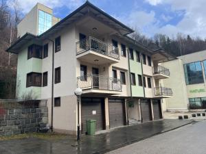 a building with two balconies on the side of it at Grand Panorama Apartment in Fojnica