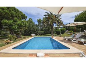 a swimming pool in a yard with trees at Alaior Villa with Private Pool in Alaior +28 photos