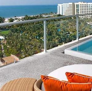 a balcony with a bed and a view of the ocean at Mayan Palace at Vidanta Vallarta in Puerto Vallarta