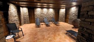 a group of chairs in a room with a brick wall at Aparthotel & Restaurant Razlog Spa Included in Razlog +117 photos