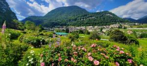 a small town in the mountains with flowers at Appartamento LILIUM in Pieve Tesino