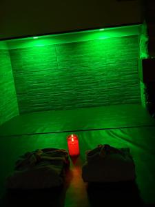 a dark room with two beds and a red candle at La parenthèse secrète in Danvou
