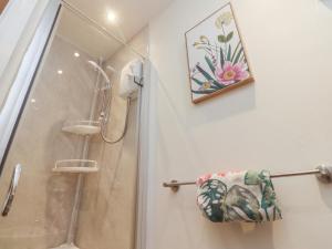 a bathroom with a shower and a towel on a rack at Willow Wood in Settle +13 photos