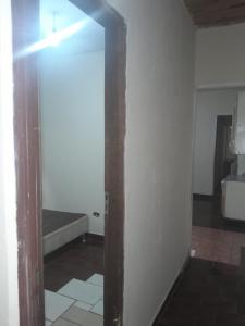 an open door to a room with a white wall at Casa agrishow in Ribeirão Preto