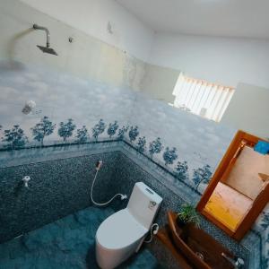 a bathroom with a toilet sitting in a bath tub at Yala Mila Villa in Gangawelana +40 photos