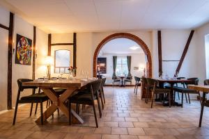 a dining room with wooden tables and chairs at Højmølle Kro in Eskilstrup
