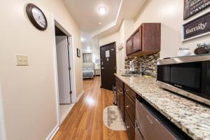 a kitchen with a counter top and a microwave at Shefah Hotel in Union City
