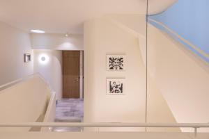 a hallway with a staircase with a glass wall at Milioni by Oniro in Athens