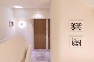 a hallway with a wooden door and a staircase at Milioni by Oniro in Athens