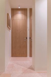 a hallway with a wooden door in a room at Milioni by Oniro in Athens