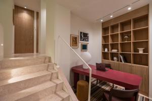 a home office with a red desk and stairs at Milioni by Oniro in Athens