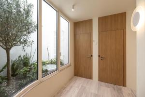 a hallway with a large window and a door at Milioni by Oniro in Athens +35 photos