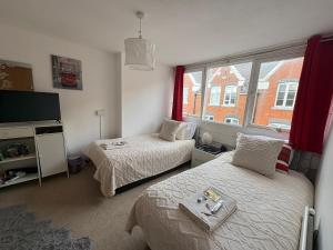 a bedroom with two beds and a window at Jeans Place Watergate St Rows near racecourse in Chester +142 photos