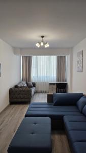 a living room with two blue couches and a couch at NORDIC Residence Apart Hotel in Suceava
