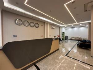 a lobby with clocks on the wall and a waiting room at MyFlower 1 Hotel in Erbil