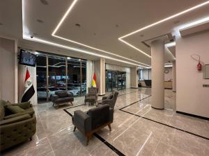 a lobby with couches and chairs in a building at MyFlower 1 Hotel in Erbil