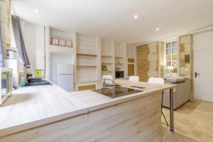 a kitchen with a large island in a room at Cour des Moines - centre ville in Le Blanc