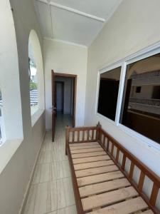 a bench in a room with a window and a hallway at Mtwapa- North Coast in Mtwapa