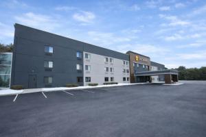 a large building with a parking lot in front of it at La Quinta by Wyndham Stevens Point in Stevens Point