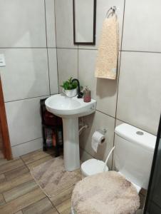 a bathroom with a toilet and a sink at Cantinho do Sossego in Prudentópolis +21 photos