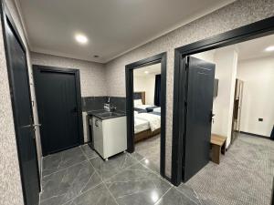 a bedroom with a bed and a bathroom with a mirror at MyFlower 1 Hotel in Erbil +31 photos