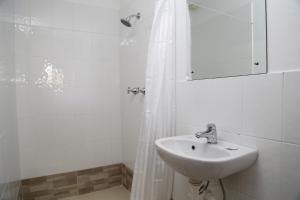 un bagno bianco con lavandino e doccia di Bua Bed & Breakfast a Nadi