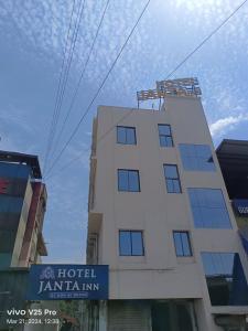 a building with a tower on top of it at HOTEL JANTA INn in Vapi