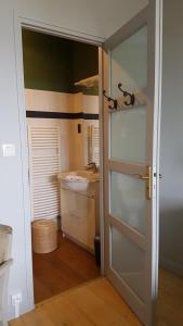 a bathroom with a door leading to a sink at chambres d'hôtes du Tilleul in Nanteuil-en-Vallée +18 photos