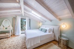 a bedroom with a white bed and a window at Villa Oliva with Private Pool by Konnect in Kato Korakiana