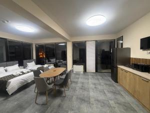 a bedroom with a bed and a table with chairs at Natali Apart-hotel in Tbilisi City