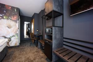 a bedroom with a bed and a desk in a room at Hotel Elsen in Grevenbroich