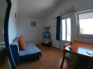 a living room with a couch and a table at Sanja Apartments Posedarje in Posedarje
