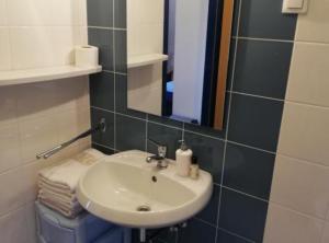 a bathroom with a sink and a mirror at Sanja Apartments Posedarje in Posedarje +15 photos