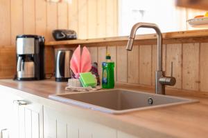 a kitchen sink with a faucet on a counter at Dünenblume - Baabe in Baabe +21 photos