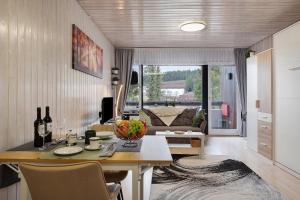a living room with a table and a couch at Quality Time auf 1000 Meter in Schönwald