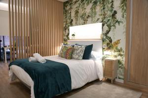 a bedroom with a large bed with a green blanket at Apartamento Diseño Myrtus in Ponteareas