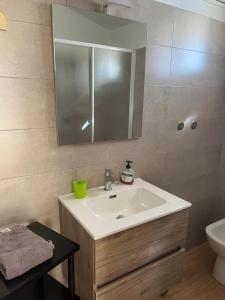 a bathroom with a sink and a mirror and a toilet at Corte Galassi in Torsa +10 photos