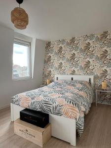 a bedroom with a bed with a zebra patterned wall at Le cocon des Sacres in Reims