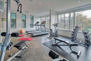 a gym with several treadmills and cardio machines at Scandic Södertälje in Södertälje