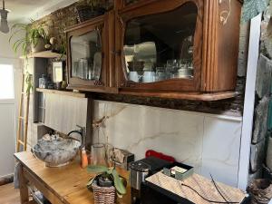 a kitchen with a counter with a wooden cabinet at My cosy space in Spa