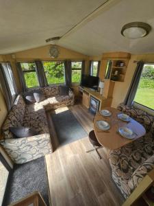 a living room with a couch and a table at Westfield 75 in Skipsea