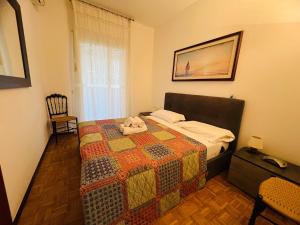 a bedroom with a bed with a quilt on it at Suite Semeria 466 - Sanremo in Sanremo