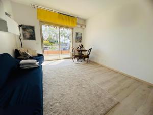 a living room with a blue couch and a table at Suite Semeria 466 - Sanremo in Sanremo