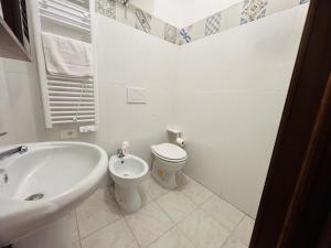 a white bathroom with a toilet and a sink at Suite Semeria 466 - Sanremo in Sanremo